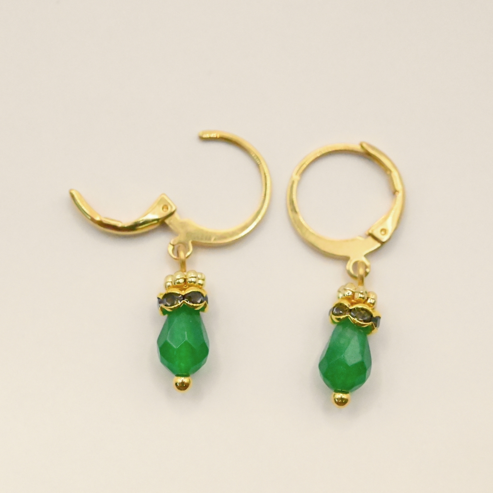 Petites boucles d'oreille parfaites pour le quotidien ou pour être portées en association avec le collier Jaipur par exemple. Elles sont très légères et d'une couleur éclatante. Un anneau strassé vient faire le pont entre la goutte et un petit anneau doré orné de mini boules typiquement indien. Bijou seul, Crédit GEMITY