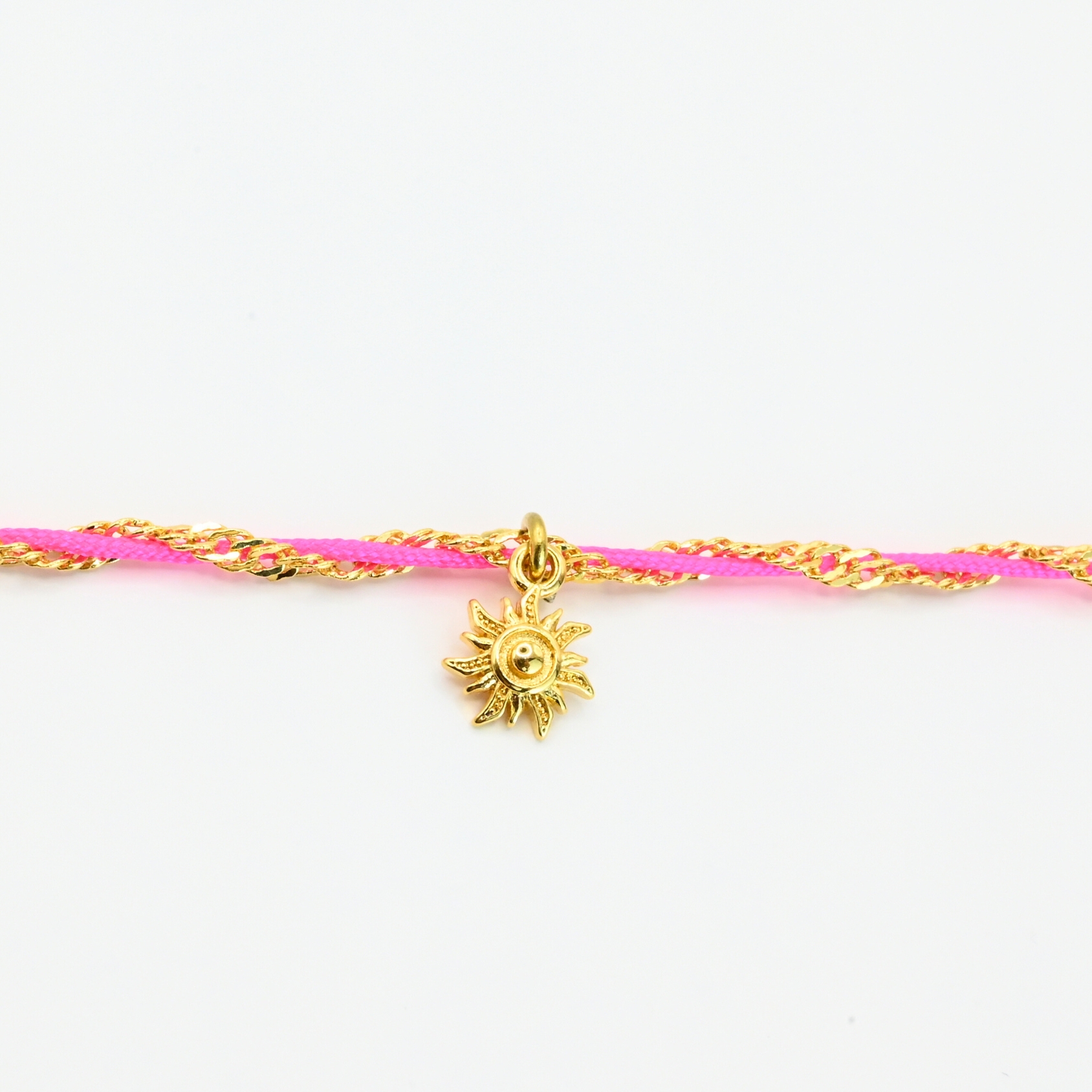 "L’élégance décontractée de la côte basque. Ce bracelet mêle fils de coton torsadé, touches dorées et couleurs vibrantes, pour une alliance parfaite entre raffinement et fraîcheur de l’océan. Orné d'un charm, il incarne une harmonie bohème et sophistiquée à porter au quotidien. Composition : Plaqué or et fils de coton torsadés. . Bijou seul, Crédit GEMITY"