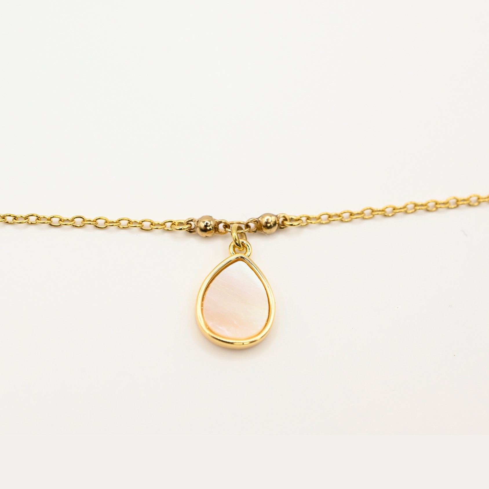 "Si vous appréciez les belles nacres naturelles, vous aimerez la beauté de ce bracelet autour de votre poignet. Ce magnifique bijou est doré à l’or fin 24 carats. Ce bracelet de 15 cm est ajustable avec sa chaîne d’extension. Cette pièce apportera une touche créative à vos tenues dans un style épuré. . Bijou seul, Crédit GEMITY"